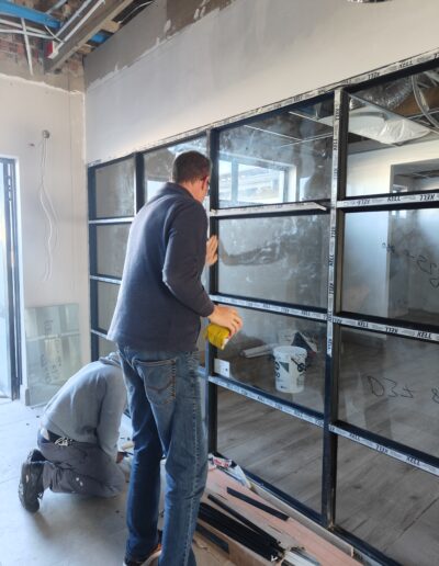 Finishing touches on newly installed aluminium windows and doors
